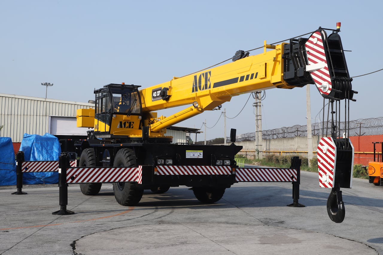 stats-img A 40 ton ACE rough terrain crane parked outdoors in an industrial yard in Faridabad, India.